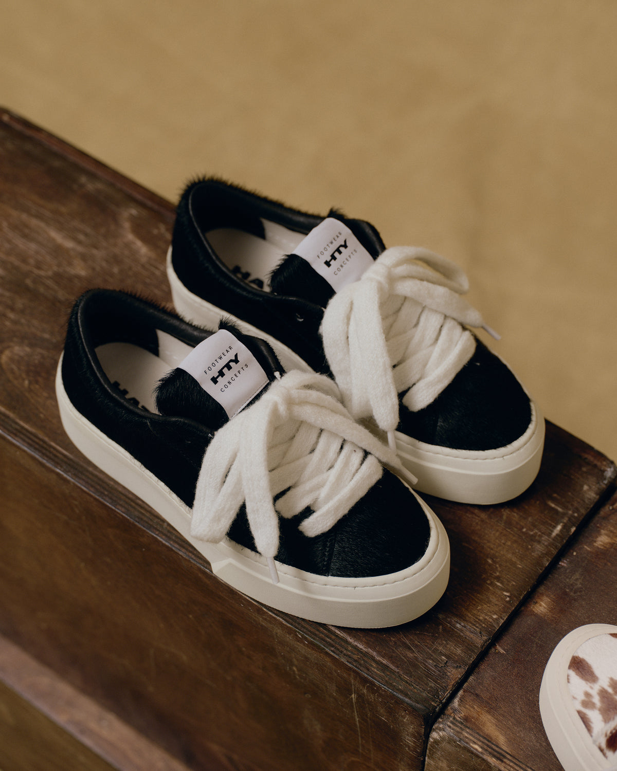 The Pony Hair OG sneakers on a wooden block